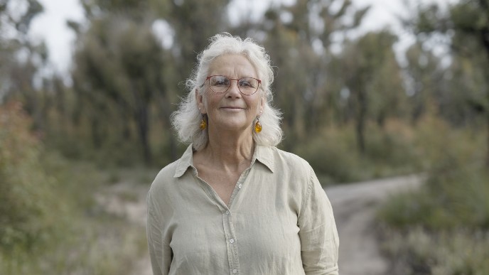 Lyn Harwood standing in the regenerating bush near Mallacoota.