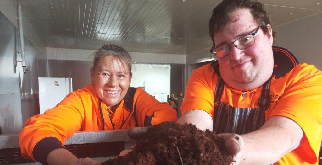 Jen and Jeremy from Asteria with their hands in the dirt for the worm farm project.